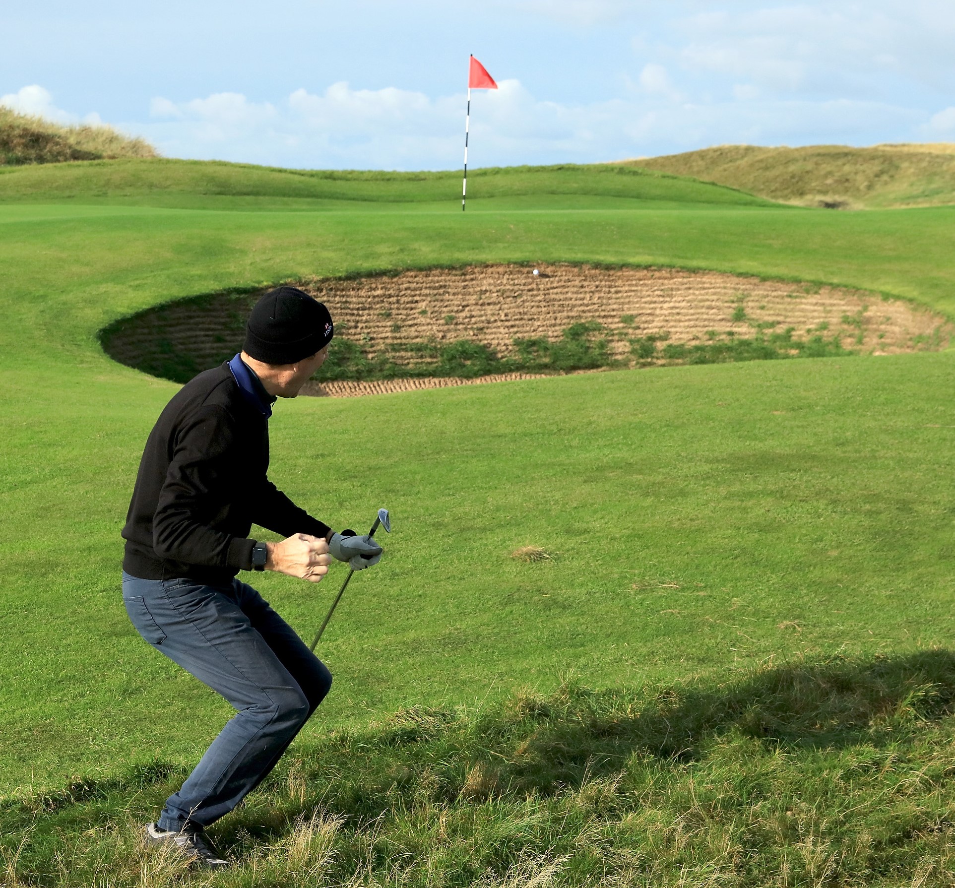 AGW Golf Captain, Peter Dixon breaks into a Highland Fling after his chip falls short into a bunker.JPG