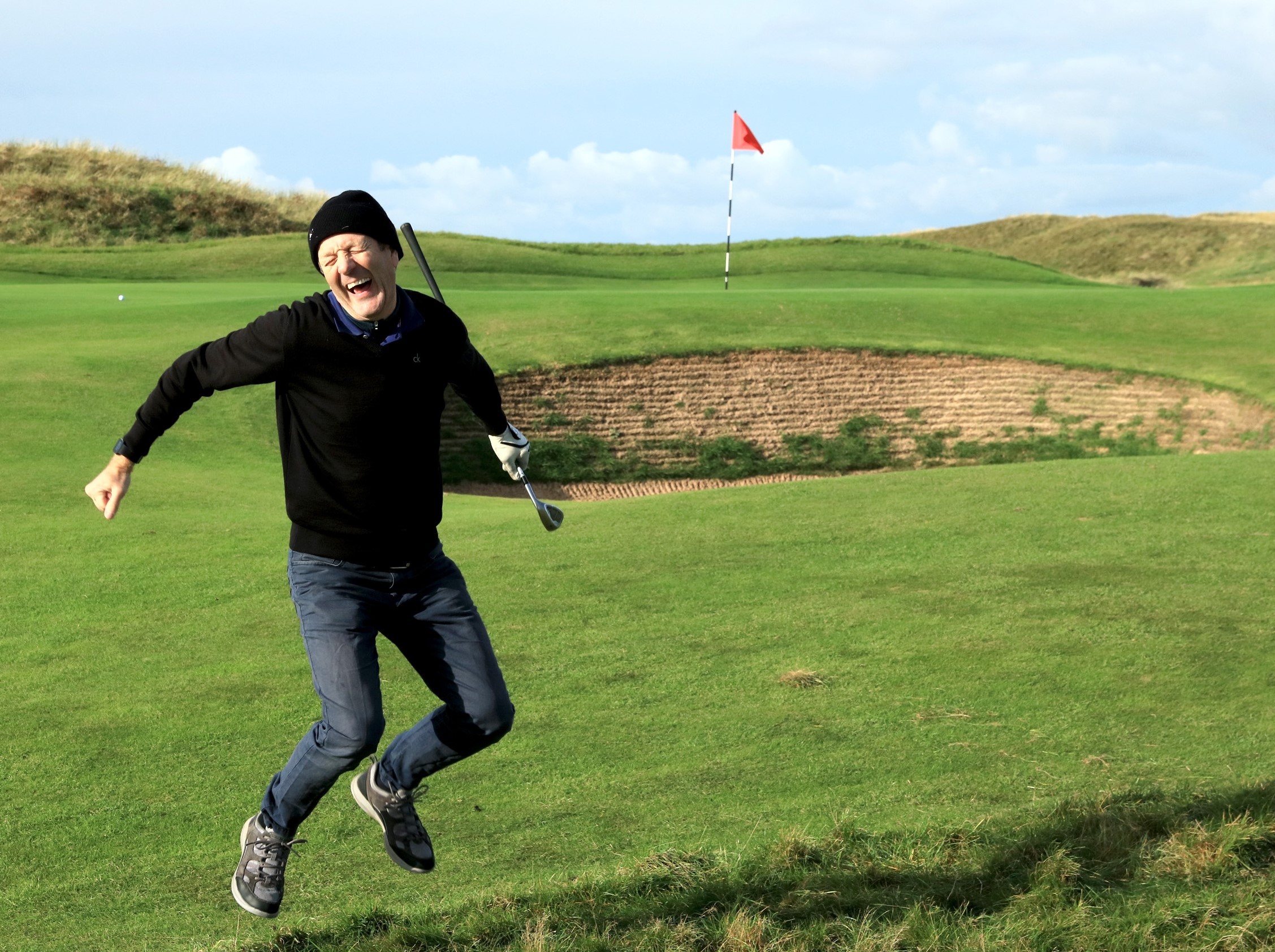 AGW Golf Captain, Peter Dixon breaks into a Highland Fling after his chip falls short into a bunker