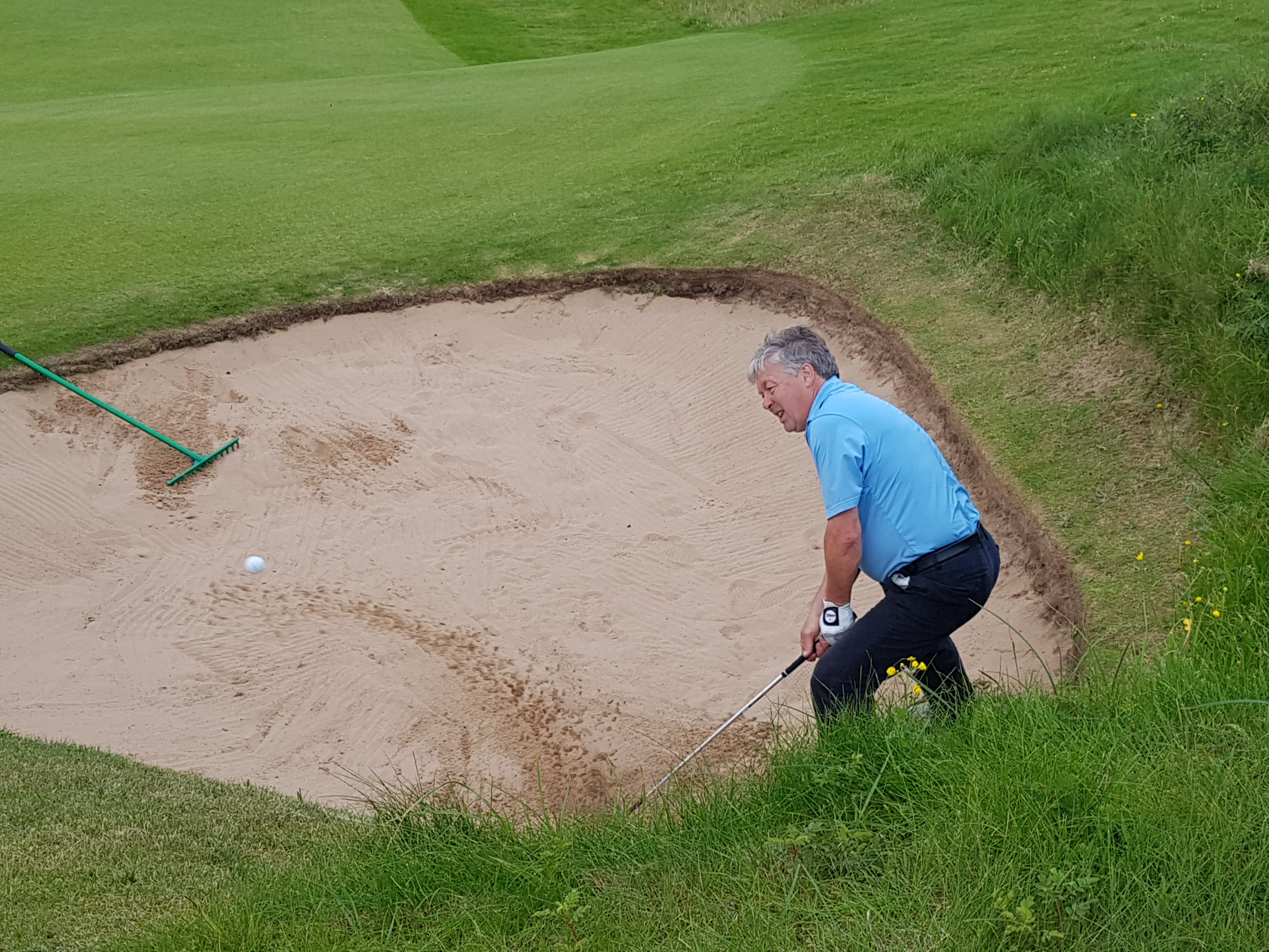 Alistair Tait gets out of a bunker at 11 on route to a great birdie.